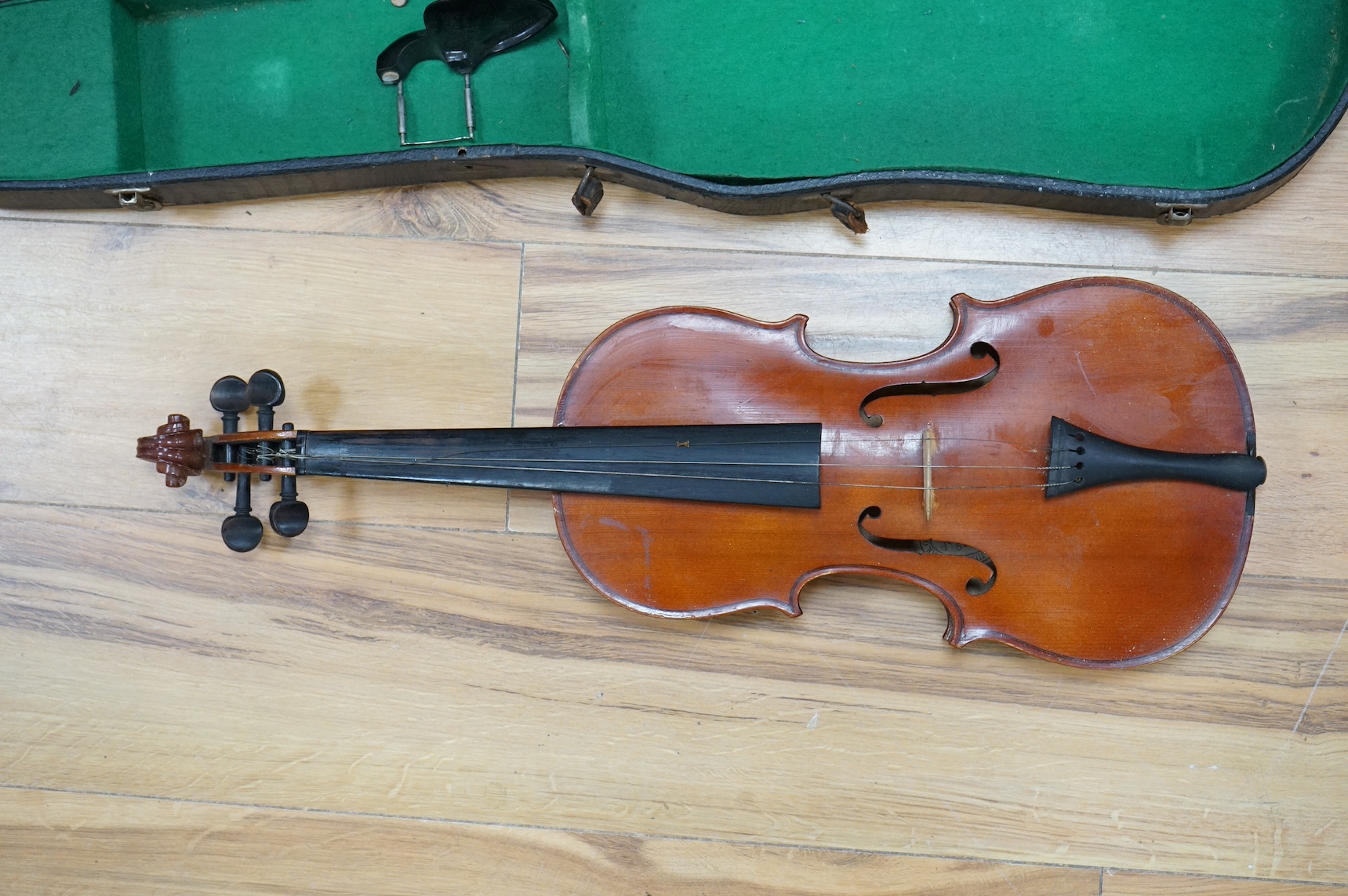 An early 20th century violin, possibly Czech, with internal label for ‘Maidstone Orchestra Association, Oxford St. London’ and bow, in case, length of back of body, 36cm., Condition - fair to good.